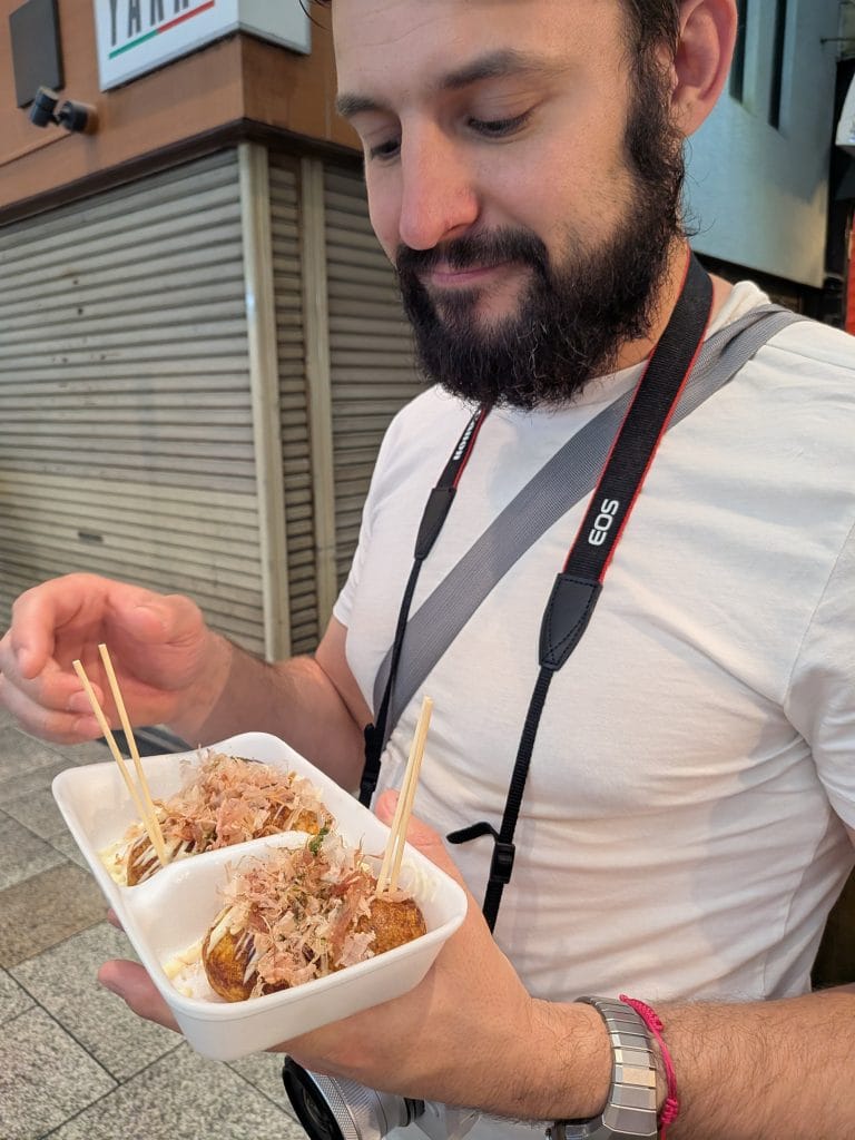 Author about to eat freshly made takoyaki (octopus balls) on Dotonbori Street in Osaka.