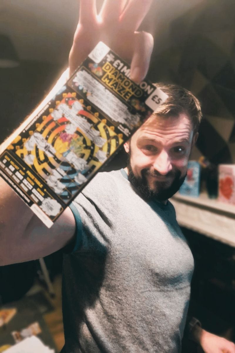 A picture pf Phil (Author) holding up his winning 50k scratch card triumphantly