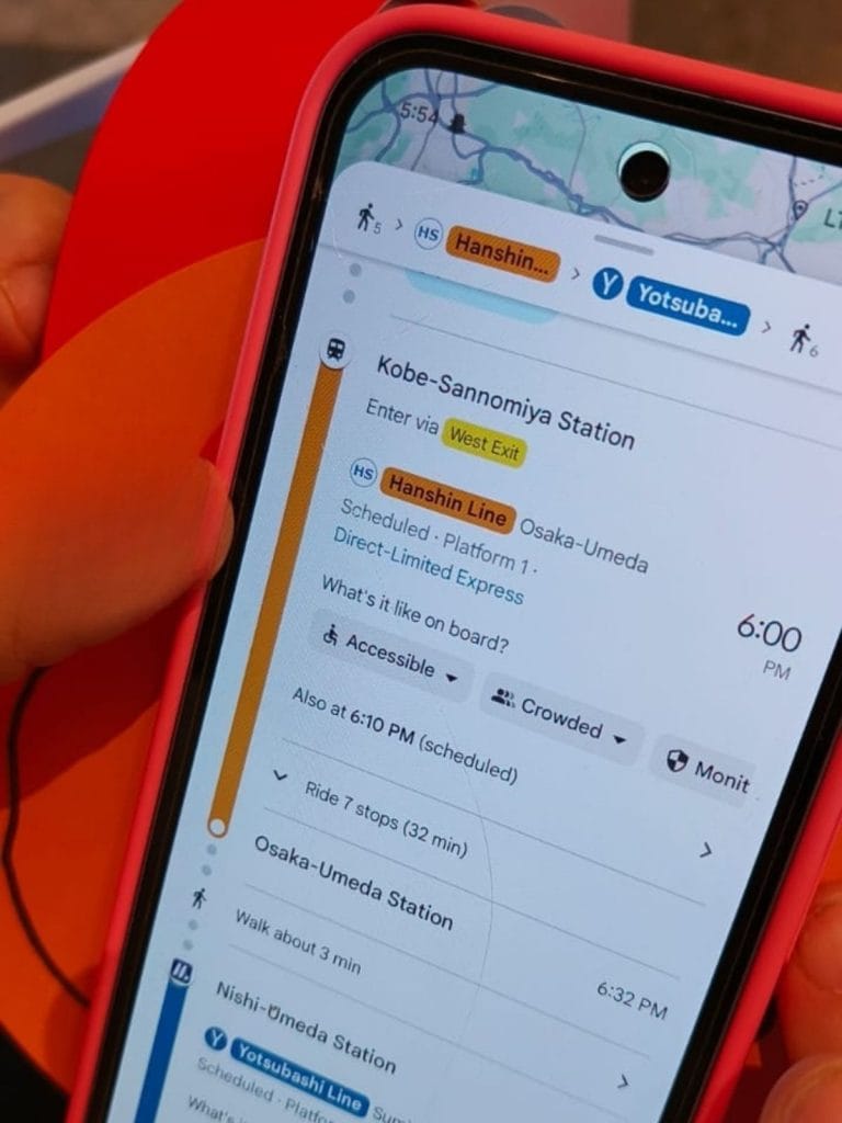 Google Maps train route from Kobe-Sannomiya Station to Osaka-Umeda Station shown on smartphone, demonstrating how to navigate Japanese train lines using ICOCA-compatible routes.