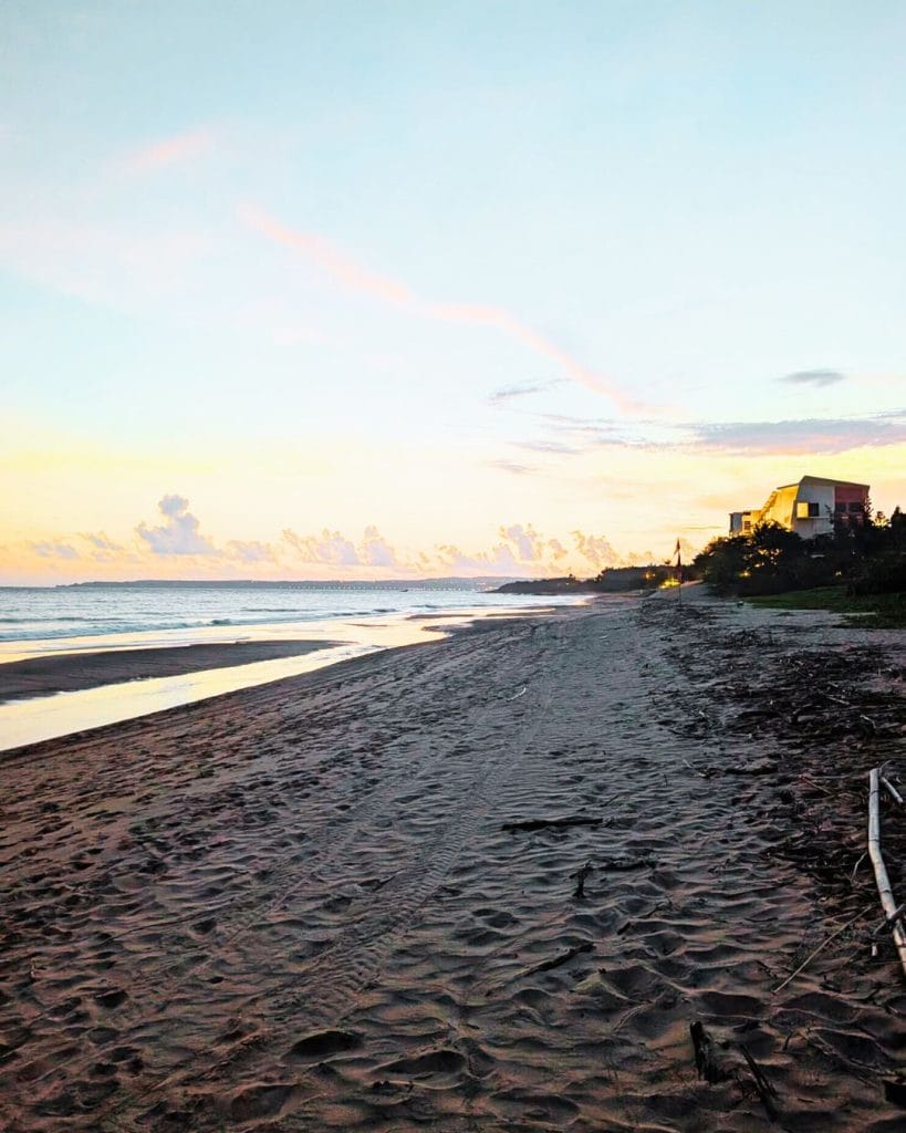 Peaceful sunset view over West Beach in Kenting, Taiwan, with empty shoreline and soft pastel skies