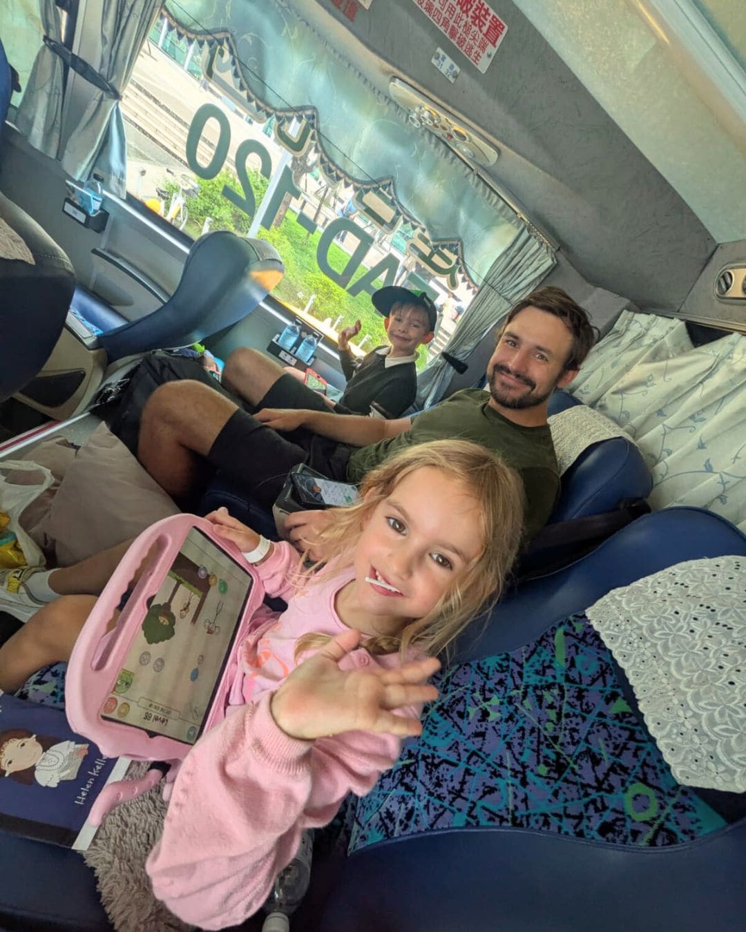 Family relaxing on the comfortable Kenting Express coach, enjoying spacious seats and air-conditioned travel through southern Taiwan