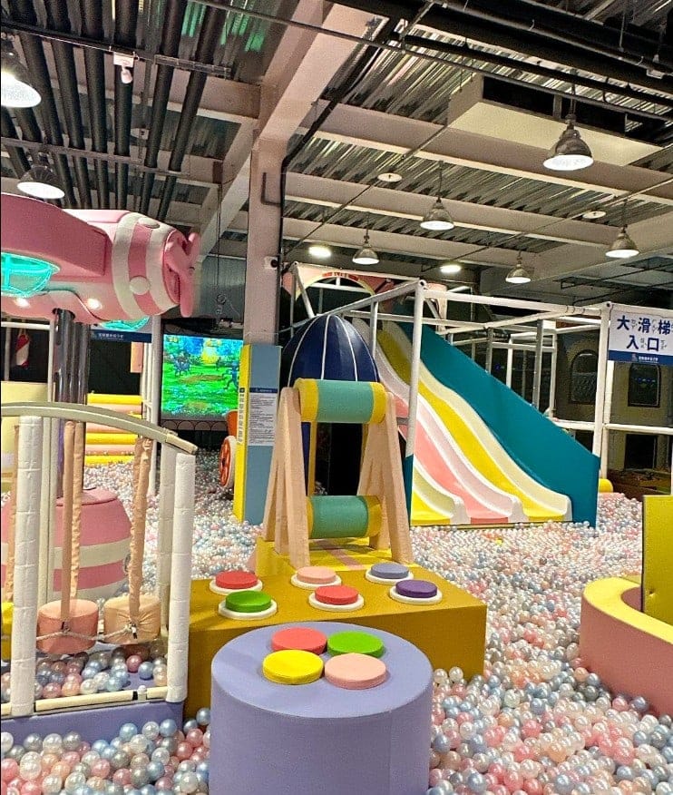Soft play area filled with pastel-coloured ball pit, interactive play equipment, and a multi-lane slide at Yilan Fun Parent-Child Center inside Jindong Shopping Mall.