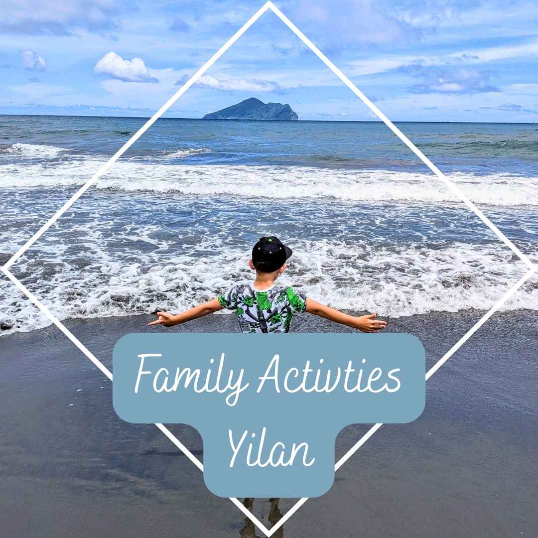 Child playing on the beach in Yilan, Taiwan with ocean waves and distant island – family activities guide.