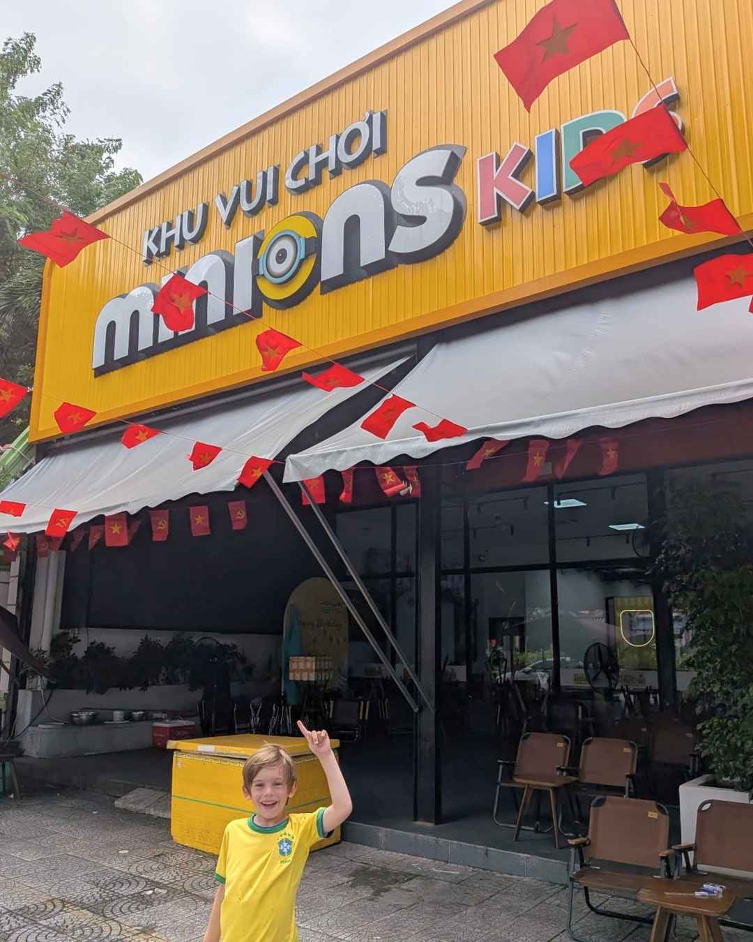 Child smiling outside Minions Kids Play Area soft play in Da Nang, Vietnam