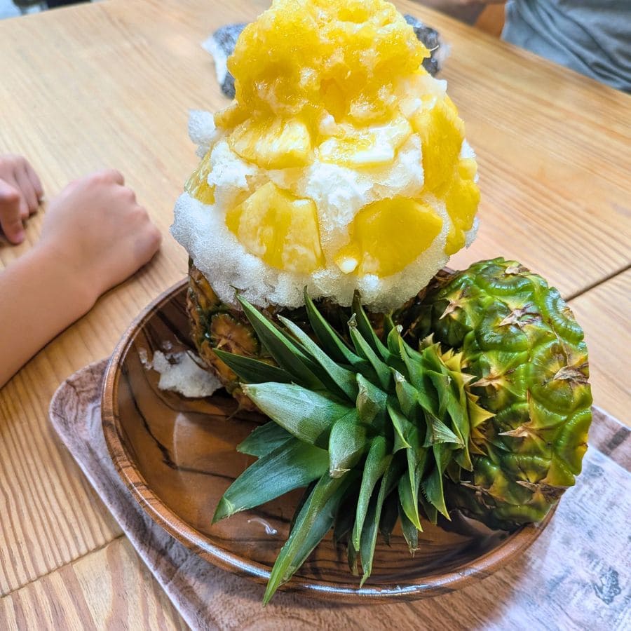 Fresh pineapple shaved ice served in a carved pineapple bowl at Pineapple Park, Okinawa