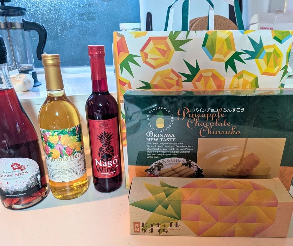 Selection of pineapple wine and pineapple cakes bought at Nago Pineapple Park in Okinawa, including Lagrima Del Sol, Nago Wine, and Pineapple Chocolate Chinsuko