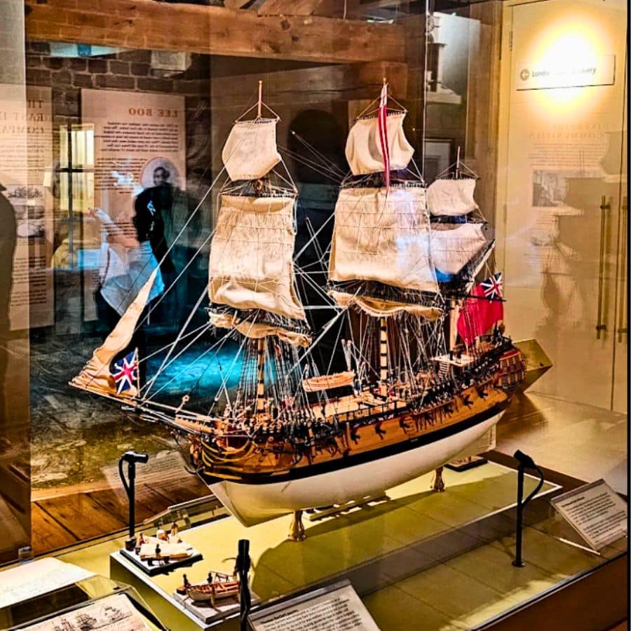 Detailed model of a historic British sailing ship on display at the Museum of London Docklands, showcasing maritime history.