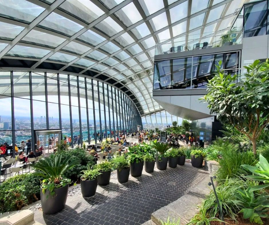 Indoor tropical garden with floor-to-ceiling windows and panoramic views over London at the Sky Garden, located at 20 Fenchurch Street.