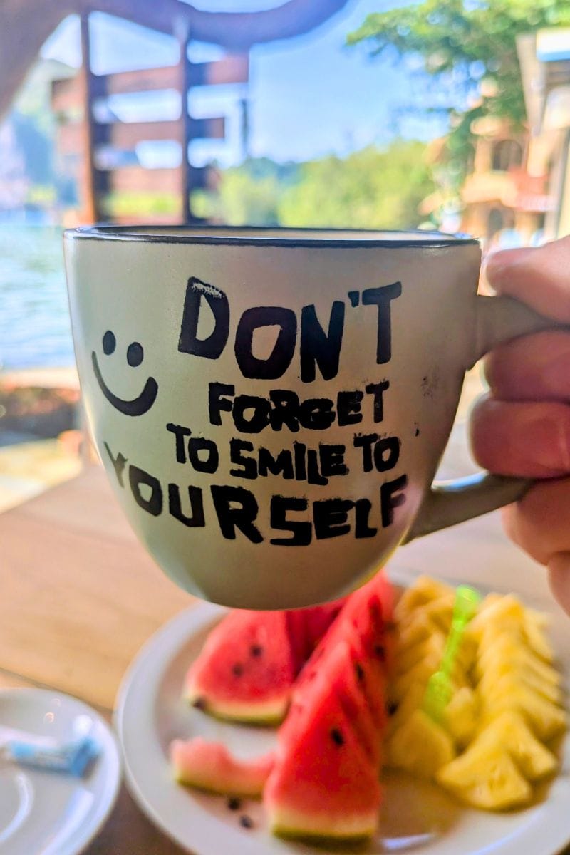 Coffee cup with dont forget to smile message from a beach cafe at Railay